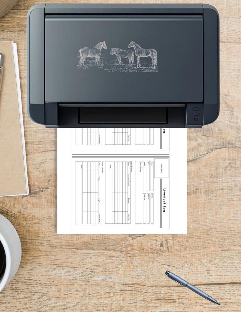 May include: A black printer with a horse illustration is printing a livestock log. The log is a two-page document with columns and rows for recording information. A pen and a cup are on the wooden surface.