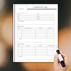 May include: A white livestock log form with sections for animal details, health records, and growth tracking. The form includes fields for name, breed, and colour, as well as space for notes. A hand holds a black and white marker.