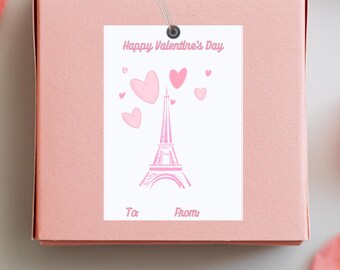 May include: A pink gift box with a white tag attached. The tag has a pink Eiffel Tower with pink hearts and the text "Happy Valentine's Day". The tag also has the words "To" and "From" written on it.