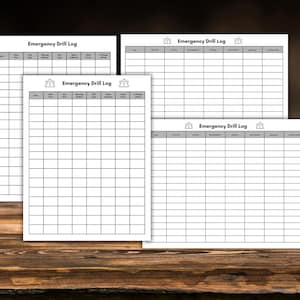 May include: Four white Emergency Drill Log sheets with a gray header and grid layout. The text "Emergency Drill Log" is printed at the top. The sheets are arranged on a wooden surface.