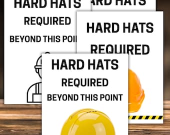 May include: A collection of safety signs on a wooden surface. The signs read "HARD HATS REQUIRED BEYOND THIS POINT" and "CAUTION". A yellow hard hat is visible, along with an orange hard hat. The signs have black text on a white background.