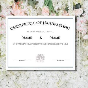 May include: A white certificate with a black border and text that reads "Certificate of Handfasting". The text continues with "That on this day... Date..." and "Name & Name who are now heart joined to each other in light & love". A Celtic knot design is centered below the text.