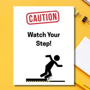 May include: A white sign with the words "CAUTION Watch Your Step!" in black and red. A black stick figure is shown tripping over a step. The sign is on a yellow surface.
