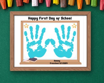 May include: A framed white board with the text "Happy First Day of School" and two blue handprints. The board also has two yellow stars and the text "Sammy Preschool 9/1/2024".