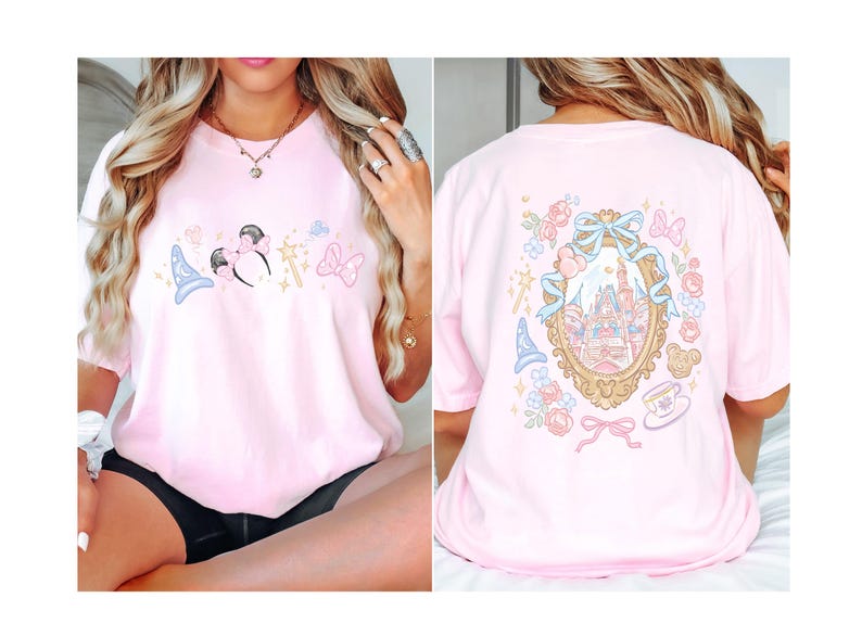 May include: A light pink t-shirt featuring a cartoon design of a mouse with a bow, a wizard hat, a wand, and a bow. The back of the shirt has a castle design inside a gold frame with flowers and bows.