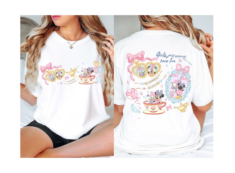 May include: White t-shirt with a cartoon design of Minnie and Daisy Mouse. The front design includes Minnie and Daisy in a teacup, and the back says "Girls just wanna have fun."