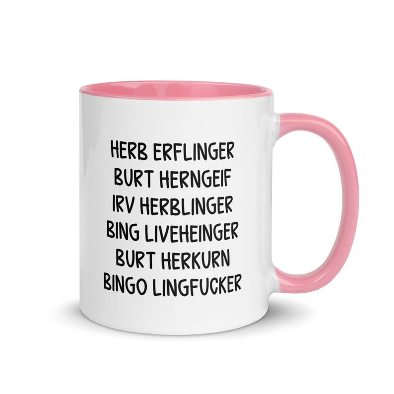 May include: White ceramic mug with a pink interior and handle. The mug features black text listing several names. The names are stacked vertically on the mug's surface. The mug is designed for beverages.