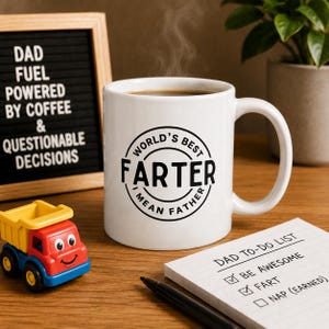 May include: A white ceramic mug with the text "WORLD'S BEST FARTER I MEAN FATHER" in a black circular design. A small toy truck and a notepad with a to-do list are also present. A sign reads "DAD FUEL POWERED BY COFFEE & QUESTIONABLE DECISIONS."