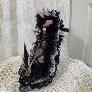 Resin glass slipper pin cushion, black and pink decoration on clear glass slipper. 5 inches heel to toe, 6 inches tall.