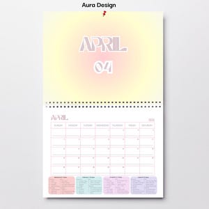 May include: Aura Design calendar for April 2024. The calendar features a gradient background with the month and date prominently displayed. The calendar grid is in a light pink color, with a spiral binding at the top.