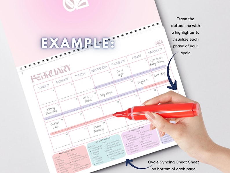 May include: A 2026 wall calendar with a pink and white design, featuring the month of February. The calendar includes a cycle syncing cheat sheet and instructions to trace a dotted line with a highlighter to visualize each phase of your cycle.