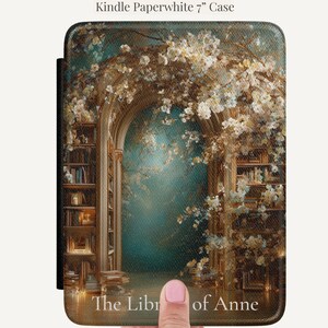 Personalized Kindle Paperwhite case featuring a vintage floral library arch design with teal background and the name Anne in soft white serif lettering.
