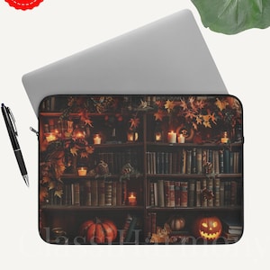 Vintage library laptop sleeve with books, glowing candles, pumpkins, and autumn leaves, protective fleece case in 12, 13, and 15 inch sizes