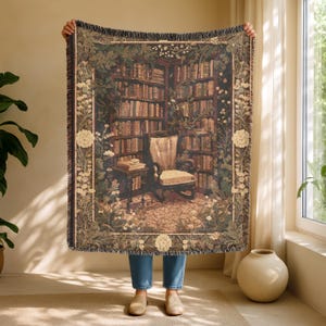 Woven blanket with a warm storybook library scene, draped over a reading chair.