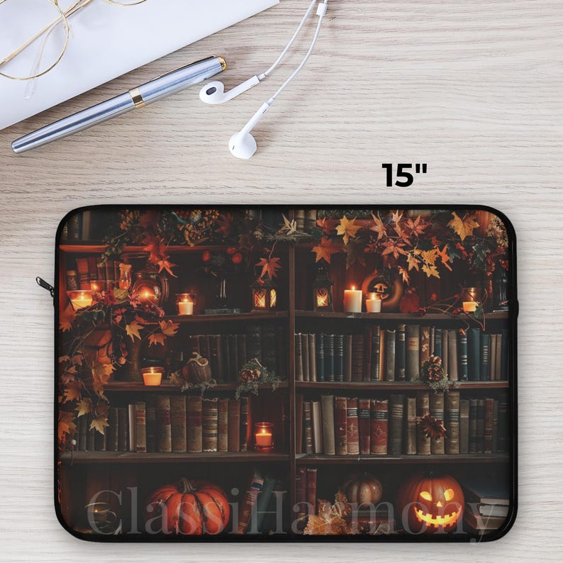 Vintage library laptop sleeve with books, glowing candles, pumpkins, and autumn leaves, protective fleece case in 12, 13, and 15 inch sizes