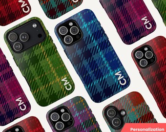 May include: A collection of phone cases with a plaid pattern in various colors, including red, green, blue, and purple. Each case features the initials "CM" in white. The cases are designed to fit a smartphone and offer a stylish, personalized look.