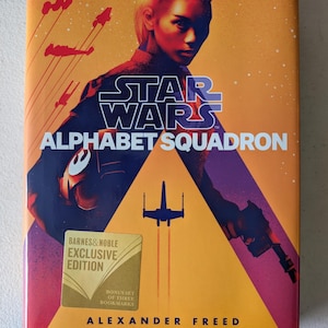 May include: A hardcover book titled "Star Wars: Alphabet Squadron" by Alexander Freed. The cover features a person with blonde hair, a starfighter, and the Barnes & Noble Exclusive Edition seal. The background is orange and purple.