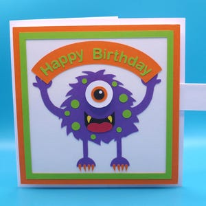 Biglietto di auguri di compleanno interattivo 3D con mostro con occhio rotante.