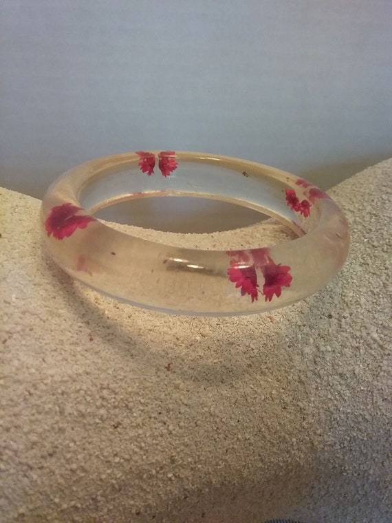 Lucite, clear bangle with red dried flowers