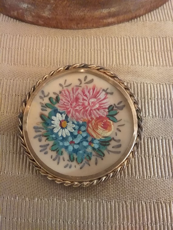 Painted floral pin with brass frame