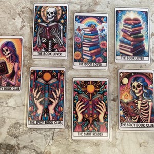 May include: Set of 7 tarot cards with colourful illustrations featuring skeletons, books, and skulls. The cards are titled "The Book Lover", "The Smutty Book Club", "The Spicy Book Club", and "The Smut Reader".