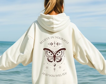 May include: A white hoodie with a brown butterfly graphic and the text "Believe in yourself and you will fly".