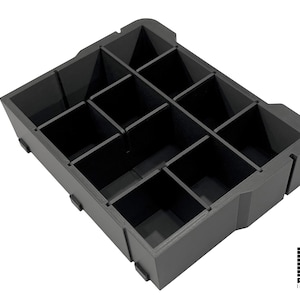 May include: A dark gray rectangular storage tray featuring twelve individual square compartments arranged in a grid. The tray has a solid outer frame with small protruding feet on the bottom edges and the text ADDITIVE INGENUITY in the corner.