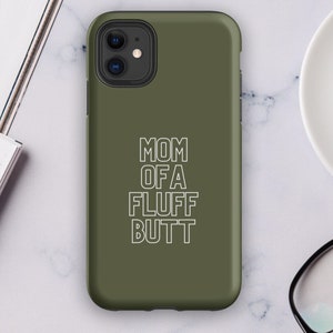 May include: A green phone case with white text that reads "MOM OF A FLUFF BUTT".