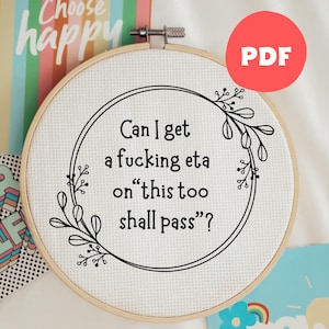 May include: A cross-stitch embroidery hoop with the text "Can I get a fucking eta on 'this too shall pass'?" in black. The design includes a floral border. A red circle with "PDF" is in the upper right.