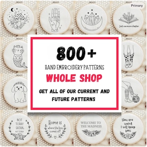 May include: A collection of circular embroidery hoops featuring various black line art designs on white fabric, including mushrooms, a palmistry hand, crystals, a cat mermaid, and text-based quotes like Just one more chapter and Home is where the bra comes off.