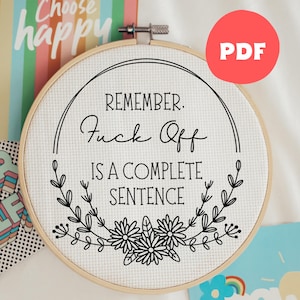 May include: A cross-stitch embroidery hoop with the text "REMEMBER. Fuck Off IS A COMPLETE SENTENCE" in black script. The design includes floral and leaf accents. A red circle with "PDF" is in the upper right corner. The background includes a colorful card that says "Choose happy".