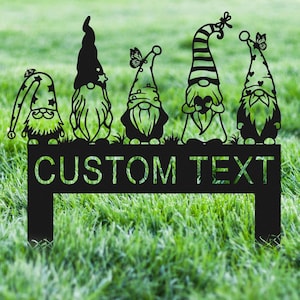 May include: Five black metal gnomes with different hats and beards standing on a black metal sign with the text "CUSTOM TEXT".