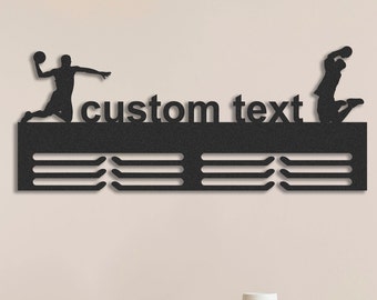 May include: Black metal sports medal display with the words "custom text". The display features silhouettes of handball players in action. Below the text are three rows of medal hangers.