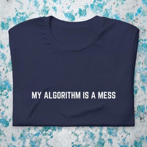 May include: A navy blue t-shirt with the text "MY ALGORITHM IS A MESS" printed in white.