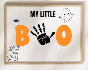 May include: A framed Halloween-themed print with the words "MY LITTLE BOO". The "B" and "O" are orange, with a black handprint in place of the "O". A spider, spiderweb, and ghost are also featured.