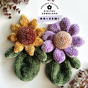 May include: Two crocheted plush flowers with green stems. The flowers are made with a velvet yarn. One flower is yellow and brown, the other is purple and brown. The flowers are on a white background. The text "CROCHET PATTERN DIGITAL DOWNLOAD NO-SEW!" is on a white circle with a purple flower in the center.