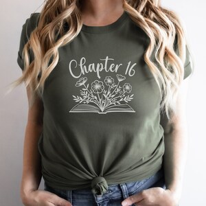 May include: A green t-shirt with the text "Chapter 16" and a white outline of a book with flowers growing out of it.