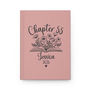 May include: A blush pink journal cover with a black and white illustration of a book with flowers growing out of it. The text "Chapter 55" is above the book and the text "Jessica 2025" is below the book.
