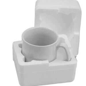May include: A white ceramic mug with a handle, packaged in a white styrofoam box.