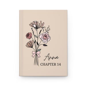 May include: A beige journal with a floral illustration and the text "Anna Chapter 14".
