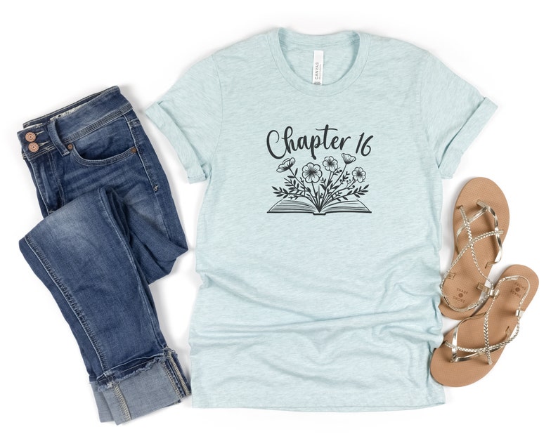 May include: A light blue t-shirt with the text "Chapter 16" and a black and white illustration of an open book with flowers growing from it.