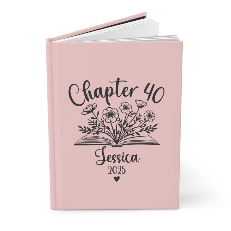 May include: A pink hardcover journal with the text "Chapter 40" and a floral design. The name "Jessica" and the year "2025" are printed below the floral design.