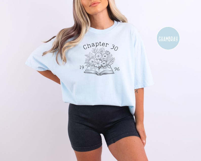 May include: Light blue t-shirt with the text "Chapter 30" above a floral design and the numbers "1996". The shirt is a soft, comfortable material.