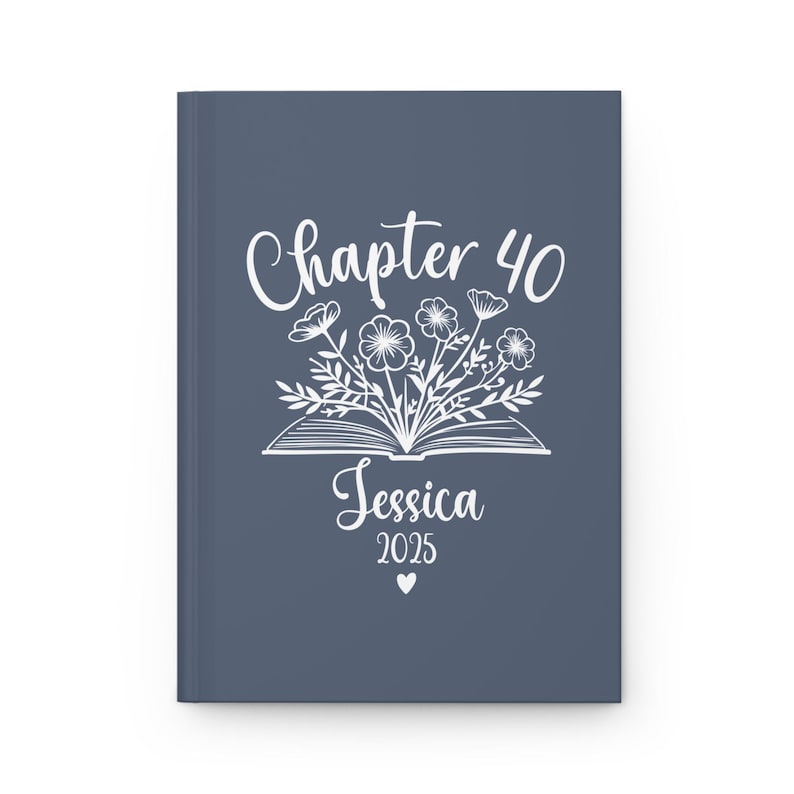 May include: A blue journal cover with white text that reads "Chapter 40 Jessica 2025" and a white illustration of a book with flowers coming out of it.