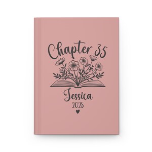 May include: A blush pink journal cover with a black floral design and the text "Chapter 35 Jessica 2025" with a small heart.