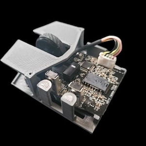 May include: A close-up of a gray 3D printed mouse with a circuit board and wires. The mouse has a wheel and a button. The circuit board has text that says "Micro-Mouse V1.0".