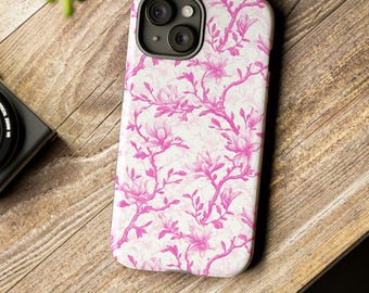 Peut inclure: Une coque de téléphone blanche avec un motif floral rose. La coque a un découpage pour l'appareil photo et un rebord surélevé autour des bords.