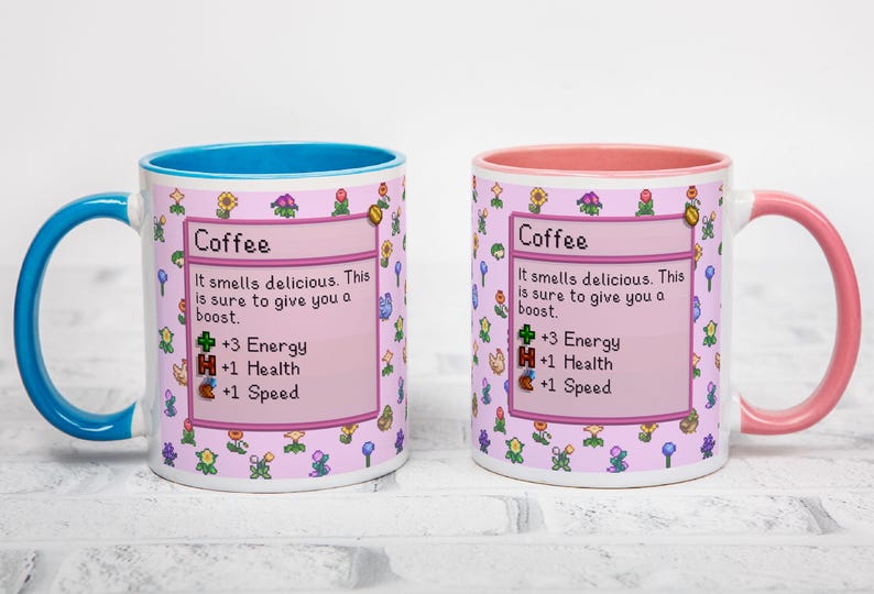 May include: Two white ceramic coffee mugs with a pink and floral design. One mug has a blue handle and interior, the other has a pink handle and interior. Each mug has the word "Coffee" and game-like stats.