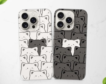 May include: Two smartphone cases featuring a repeating pattern of stylised cat faces. The left case is white with dark grey cat outlines and one solid dark grey cat. The right case is dark grey with white cat outlines and one solid white cat.