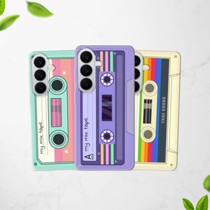 May include: Three smartphone cases featuring retro cassette tape designs. The left case is mint green with pink accents and the text 'my mix tape'. The center case is purple with 'A SIDE' and 'my mix tape'. The right case is cream with a rainbow stripe.